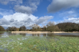 Burton washlands holding water with blue sky and clouds