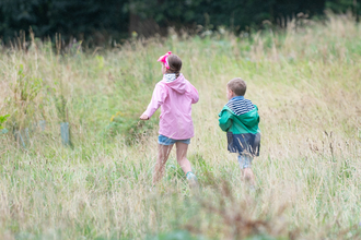 Children walking through grass Playday 2024