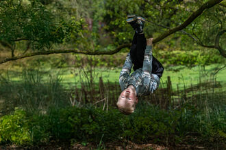 Boy swinging from tree Easter 2025