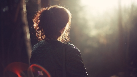 woman looking into the sun