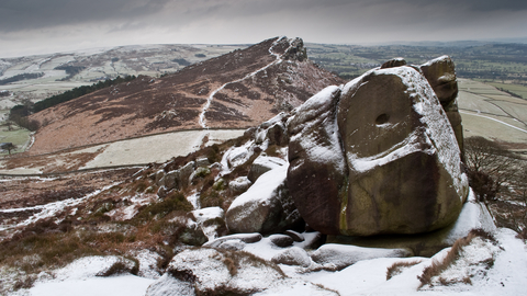 A rocky landscape partially covered by snow