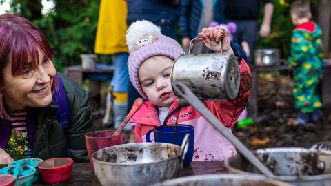 Child at mud kitchen by Adrian Clarke