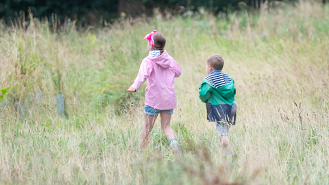 Children walking through grass Playday 2024