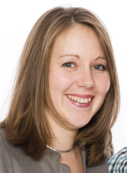 A photographic portrait of a woman with straight brown hair. 