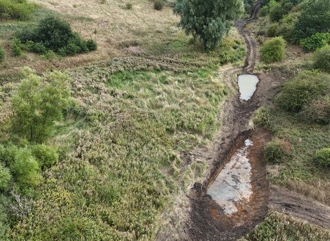A new pond holds water in a valley